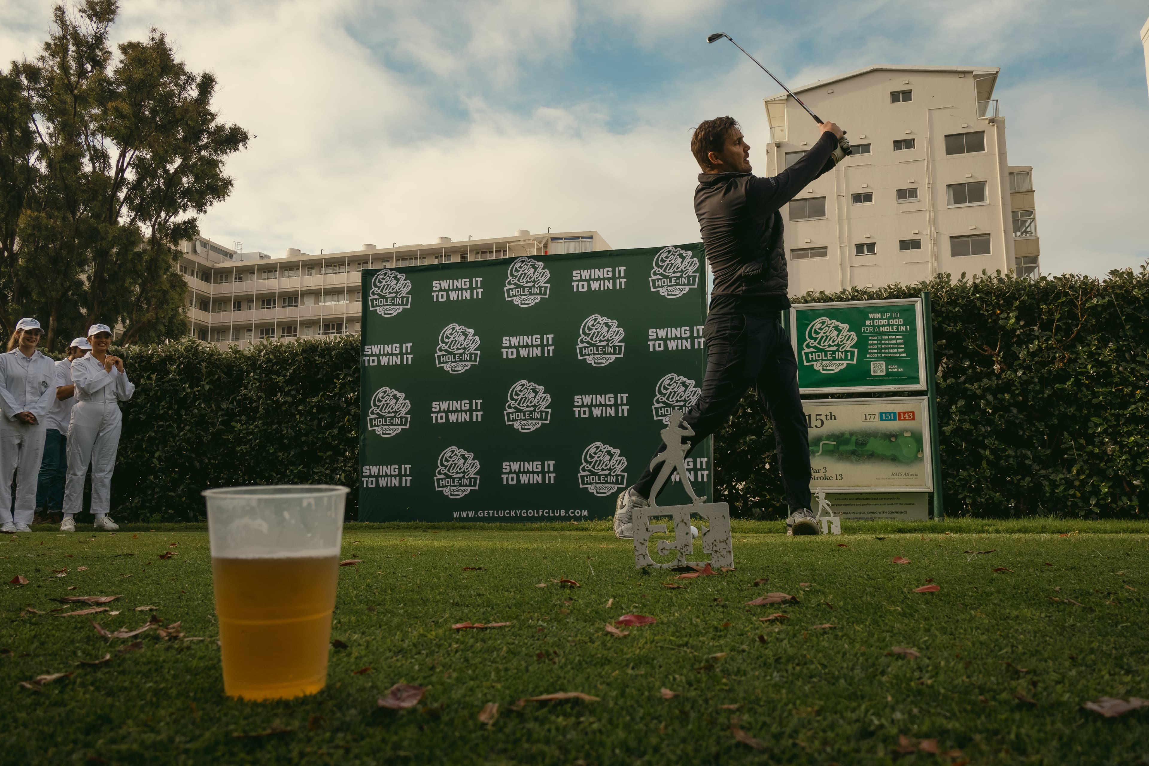 Golfer mid-swing at the Get Lucky Hole-in-One Challenge